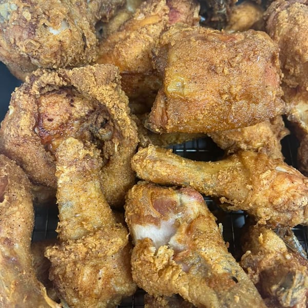 Close-up of golden-brown fried chicken pieces from Pa's Chicken Coupe, showcasing crispy texture.