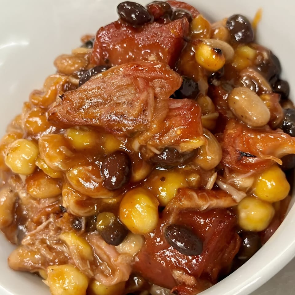Close-up of Pa's Chicken Coupe's chili, featuring chicken, beans, corn, and tomatoes in a rich sauce.
